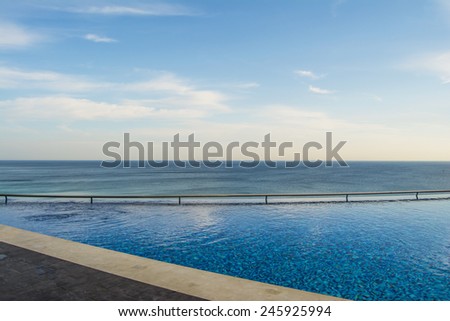 Pool with handrails and sea views