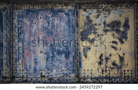 Photo closeup old rusty grunge steel aluminum fragment of protective structure made of metal plates sheets assembled with button head rivets on armor textured background, horizontal picture. Royalty-Free Stock Photo #2459272297