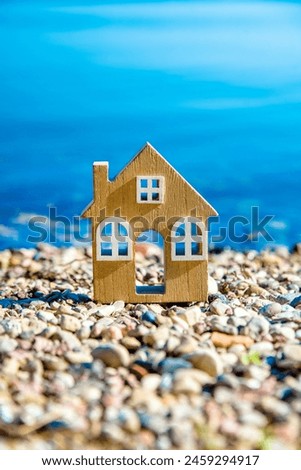 The symbol of the house standing on the seashore
