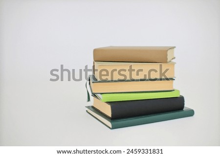  stack of green books on a gray background.