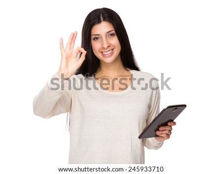 Woman use of tablet and ok sign