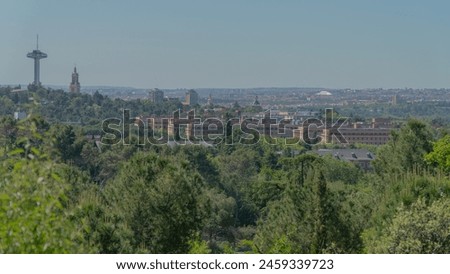 Skyline of the city of Madrid on a sunny day surrounded by nature pictured from Dehesa de la Villa park in the northern part of the city