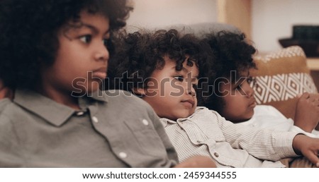 Children, relax and watching tv on couch with siblings together for movie subscription, network and decision for cartoon. Boys, sofa and rest in lounge for kids show and streaming service in Colombia