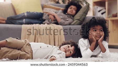Children, relax and watching tv in home with siblings together on carpet for film, entertainment and decision for cartoon. Boys, sofa and rest in lounge for kids show and streaming movie in Colombia