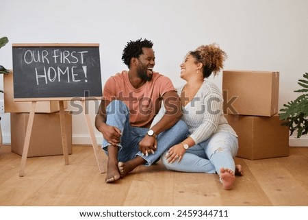 Board, box or happy couple laughing in new house in real estate, property investment or buying apartment. Our first home, words or man on floor with smile, sign or woman to celebrate moving in rent
