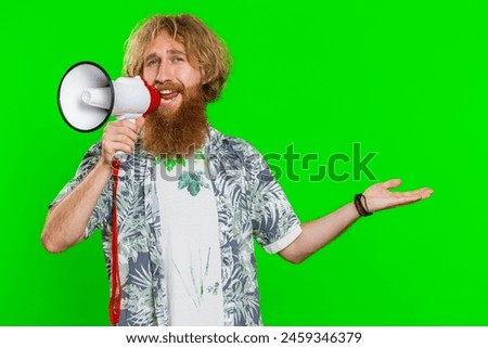 Happy caucasian man talking with megaphone, proclaiming news, loudly announcing advertisement discounts sale, using loudspeaker to shout speech. Redhead guy isolated on green chroma key background