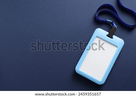 Blank badge with string on blue background, top view. Space for text