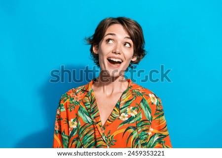 Photo of excited charming girl wear stylish clothes looking up interesting offer proposition isolated on blue color background Royalty-Free Stock Photo #2459353221