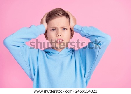 Photo of impressed disappointed boy arms touch head bad news empty space isolated on pink color background