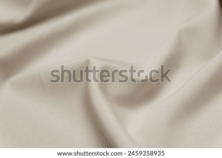 Mauled beige-colored fabric texture background. This fabric is made of polyester and spandex. Royalty-Free Stock Photo #2459358935