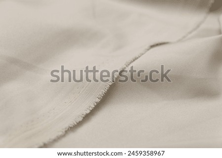 Mauled beige-colored fabric texture background. This fabric is made of polyester and spandex. Royalty-Free Stock Photo #2459358967