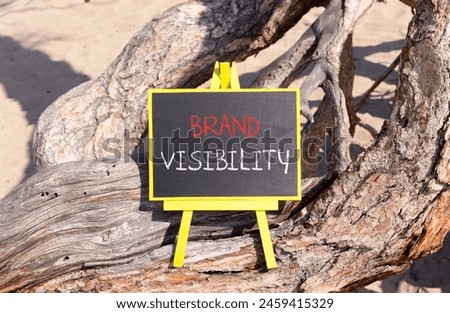 Brand visibility symbol. Concept words Brand visibility on beautiful black yellow blackboard. Beautiful tree background. Business branding and brand visibility concept. Copy space.