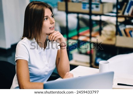 Contemplative young hipster girl thinking about some ideas for coursework studying in library with wifi connection and laptop computer, pensive clever student analyzing information doing homework Royalty-Free Stock Photo #2459433797