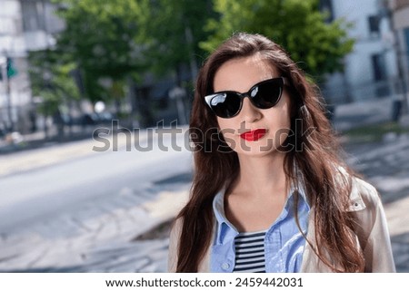 portrait of a girl in black glasses with red lips. High quality photo