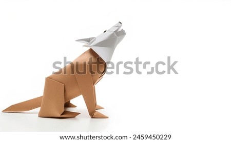 Animal concept origami isolated on white background of a dog howling - Canis lupus familiaris - with copy space side, simple starter craft for kids