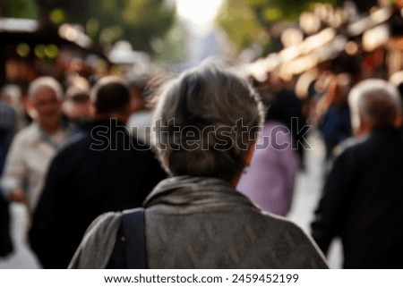 blurred for background. Crowd of people on the street. people walking on the city street. A blurry people walking. Urban, social concept. Abstract urban background with blurred buildings and street.