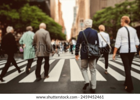 blurred for background. Crowd of people on the street. people walking on the city street. A blurry people walking. Urban, social concept. Abstract urban background with blurred buildings and street.