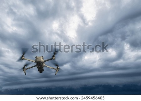 UAV drone copter flying with digital camera.Drone with high resolution digital camera. Flying camera take a photo and video.The drone with professional camera takes pictures of the rain storm on sea