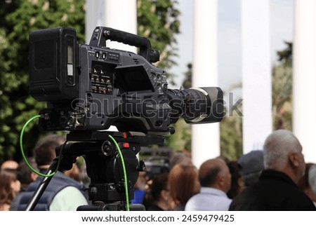 professional video camera with lens used for a live news broadcast. Professional Camera Lens. digital video camera