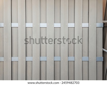 Modern Beige Fence with Metal Clamps Close-Up