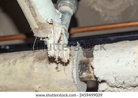 Photography of Thermal system insulation containing asbestos fibers in elbows.