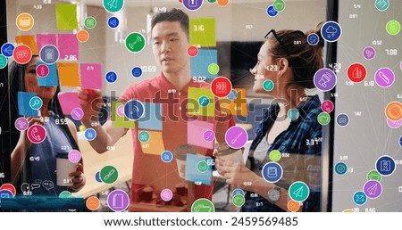Image of colorful circles with icons and numbers, diverse coworkers discussing over sticky notes. Digital composite, business, ideas, brainstorming, meeting, office, computer icons, technology.