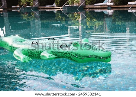 Float in shape of crocodile in swimming pool at luxury resort