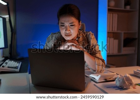 Asian businesswoman is stressed and bored from working long hours on laptop. Tired young woman with a headache at the office Feeling sick at work Office syndrome concept.