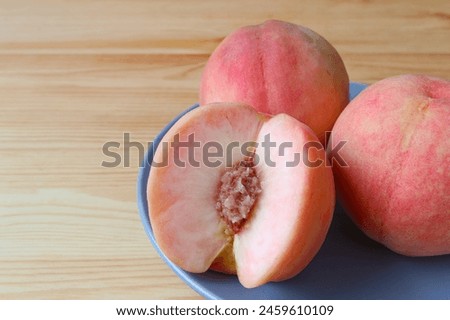 Delectable Fresh Ripe Peach Showing Its Juicy Flesh Royalty-Free Stock Photo #2459610109