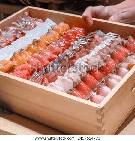 The composition of nigiri sushi with tuna, salmon, shrimp, butterfish on rice
