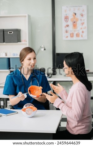 Portrait of female doctor explaining diagnosis to her patient. Doctor Meeting With Patient In Exam Room. A medical practitioner reassuring a patient in hospital