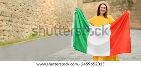 Beautiful young woman with Italian flag outdoors. Banner for design