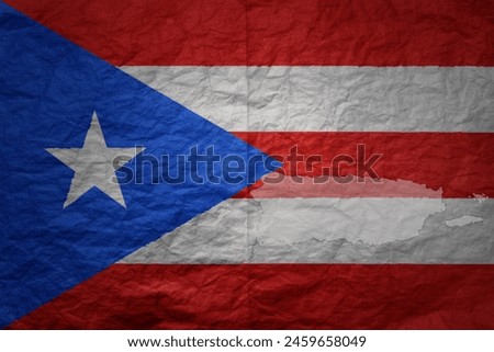 colorful big national flag and map of puerto rico on a grunge old paper texture background