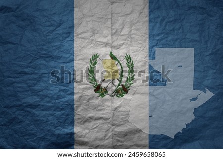 colorful big national flag and map of guatemala on a grunge old paper texture background