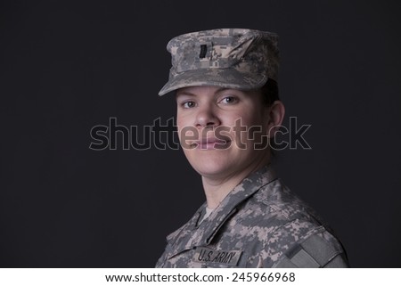 Military woman close up portrait, studio low key
