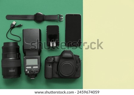 Composition with modern photographer's equipment and mobile phone on color background