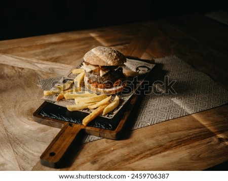 Burguer with patatoes in a table of restaurant