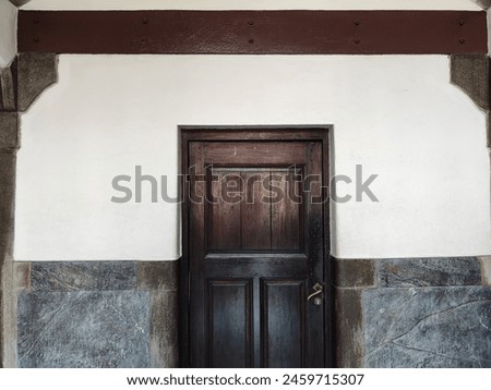The door is dark brown and very ancient