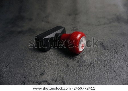 is a round stamp with red algae and black background, has good detail