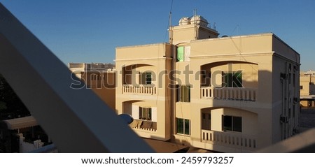 A picture of a residential building in the middle east(Bahrain) with the sun making a beautiful presence 