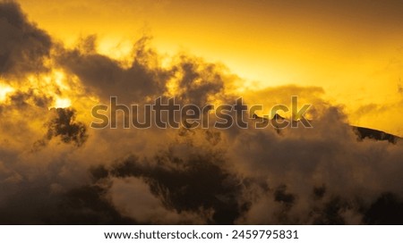 Great view of the sunset over the mountains with several clouds.  Royalty-Free Stock Photo #2459795831