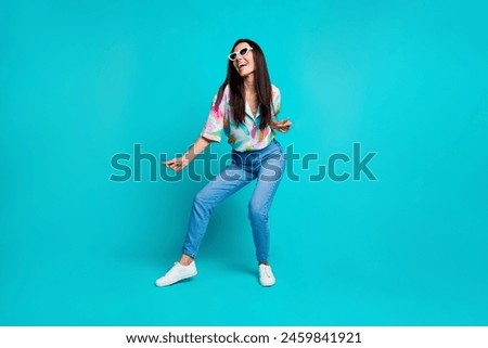 Photo of glad cheerful positive woman wear stylish print clothes dance weekend good mood isolated on cyan color background