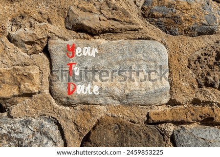 YTD year to date symbol. Concept words YTD year to date on beautiful big stone. Beautiful stone wall background. Business YTD year to date concept. Copy space.