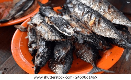 Pasangkayu, West Sulawesi, Indonesia - 9-5-2024. This is grilled fish served on an orange plate Royalty-Free Stock Photo #2459861469