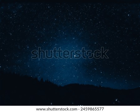 Explore the beauty of the cosmos with this stunning image capturing the starry night sky above a dark mountain silhouette, perfect for wall art and educational use