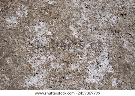 The texture of durable concrete mixed with stone chips. Stone background Royalty-Free Stock Photo #2459869799