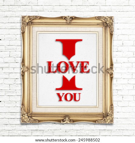 "I love you" word in golden vintage photo frame on white brick wall,Love concept