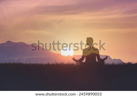 Man in yoga pose, zen meditation at sunset.
