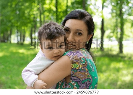mother with baby, child in parent's arms, baby in pink overalls, baby laughing, happy baby, boy, girl, summer vacation, summer weekend, maternity leave