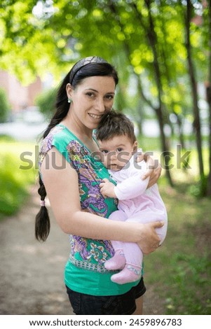 mother with baby, child in parent's arms, baby in pink overalls, baby laughing, happy baby, boy, girl, summer vacation, summer weekend, maternity leave